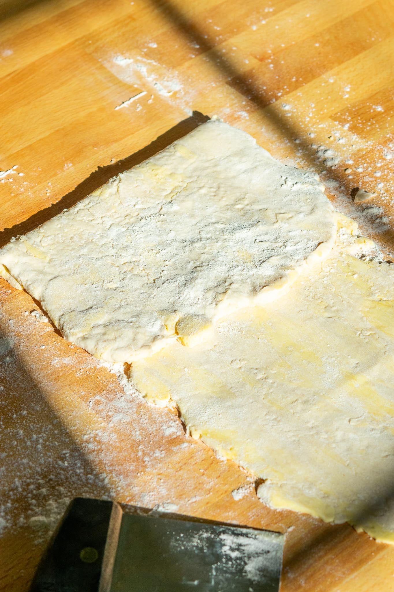 Folding top third of Sourdough pie crust dough onto itself for lamination