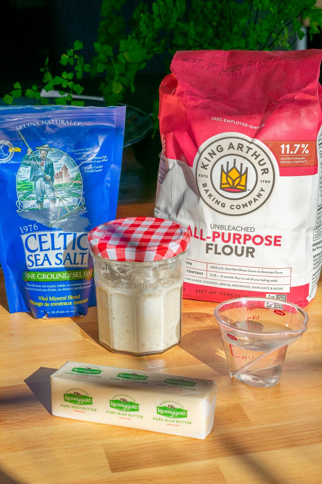 Ingredients needed for sourdough pie crust including flour, salt, sourdough starter, ice water, and butter