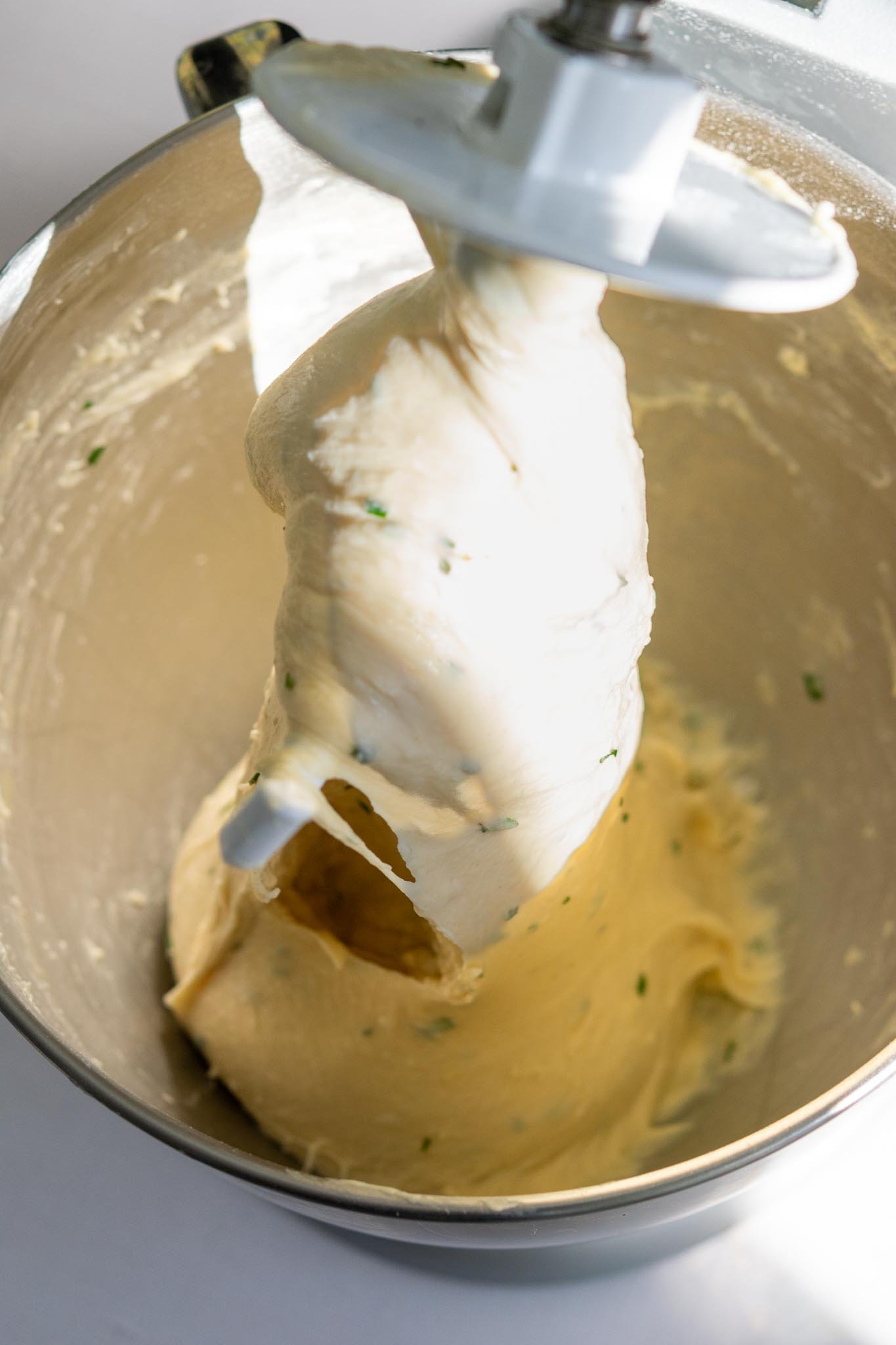 Fully mixed sourdough dinner roll dough in stand mixer bowl with the bread hook attachment