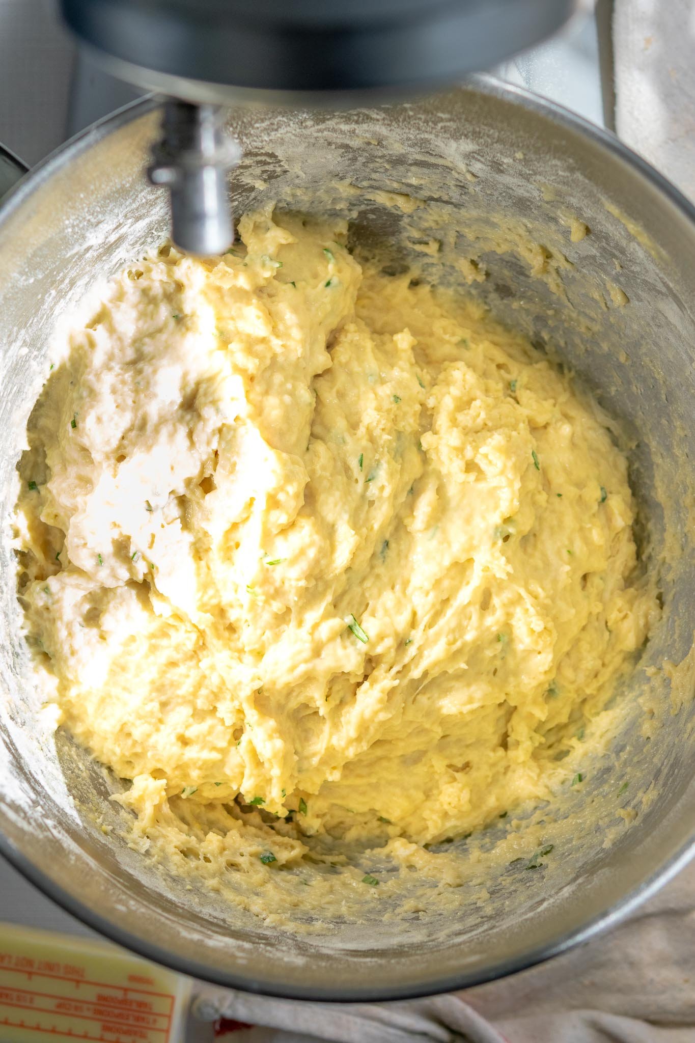 Shaggy sourdough dinner roll dough in stand mixer bowl before resting