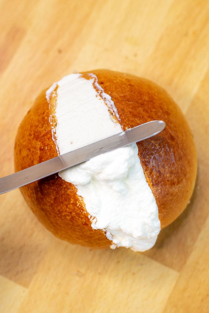 Using an offset spatula to make the whipped cream flush on maritozzo