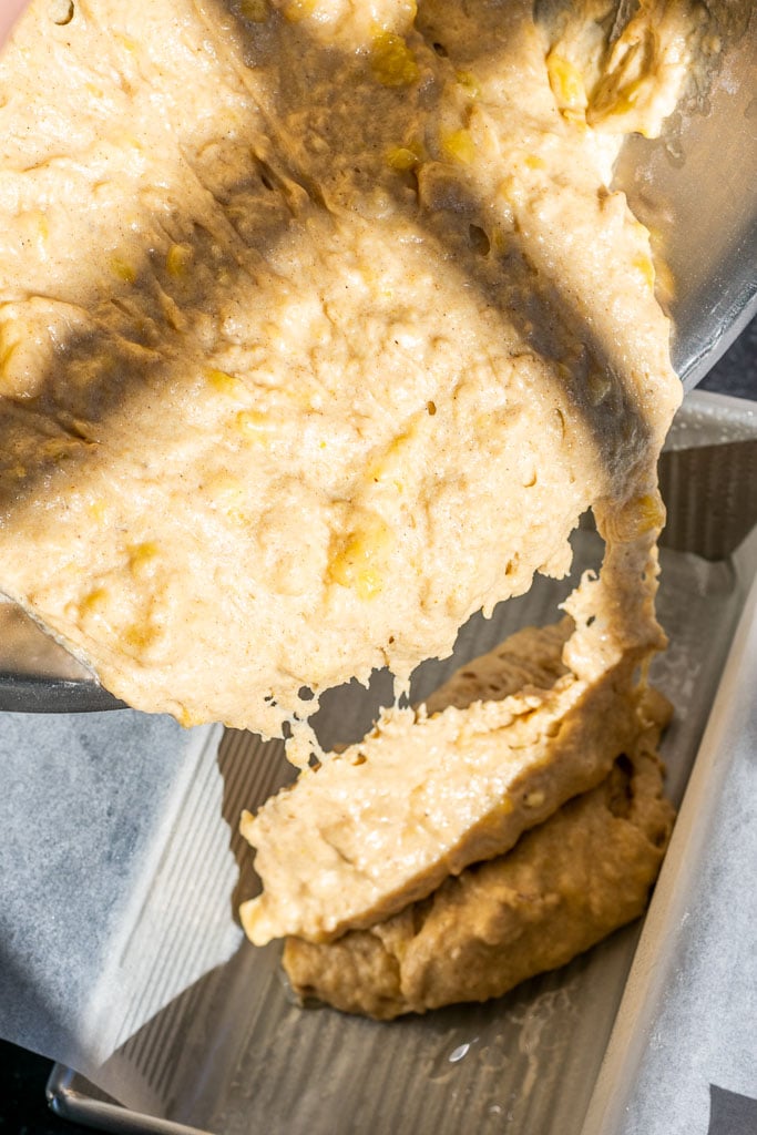 Pouring the sourdough banana bread into the bread loaf pan