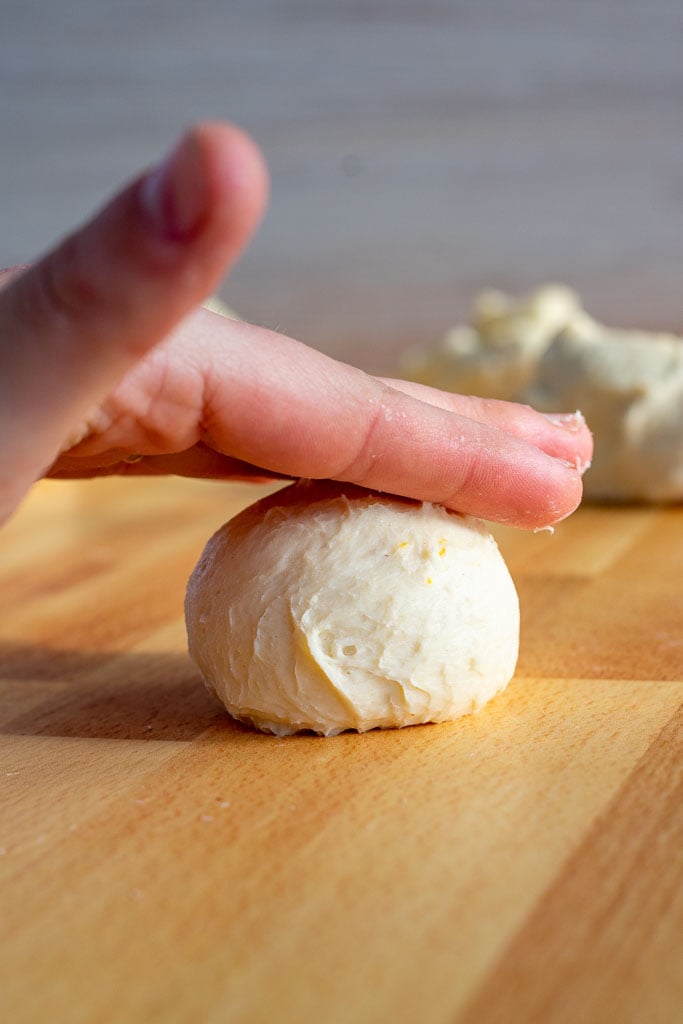 Hand rolling on top of dough shaping it