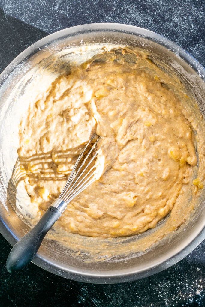 sourdough banana bread batter mixed in bowl with a whisk