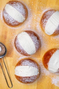 Multiple sourdough maritozzi with whipped cream and dusted with powdered sugar
