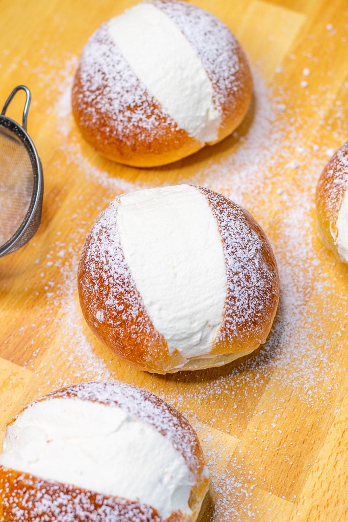 Sourdough maritozzi with whipped cream dusted with powdered sugar