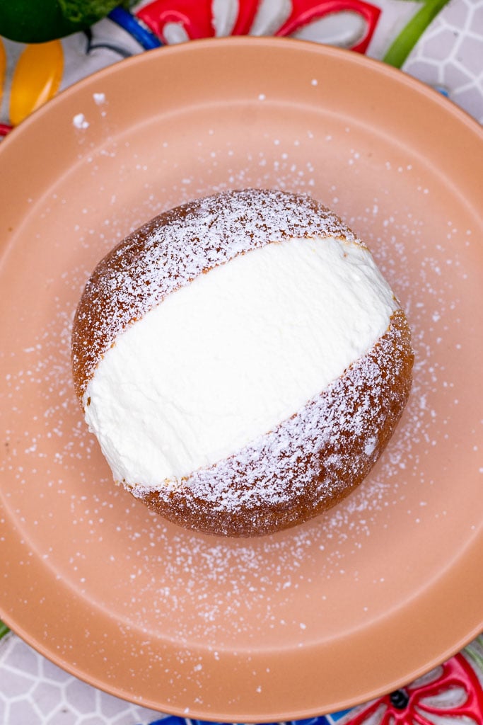 Sourdough maritozzo dusted with powdered sugar on a plate