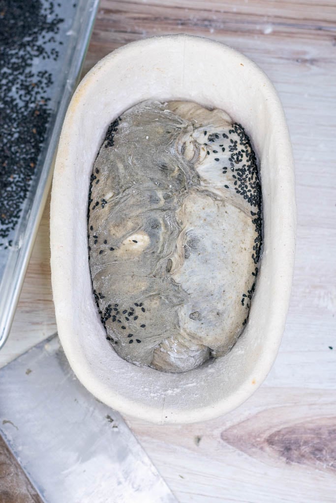 Black sesame sourdough bread shaped in banneton for overnight proof