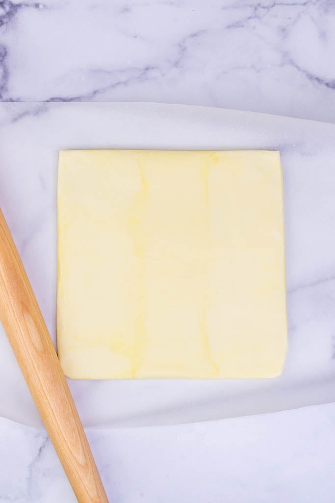 Butter block formed into square and wrapped in parchment paper