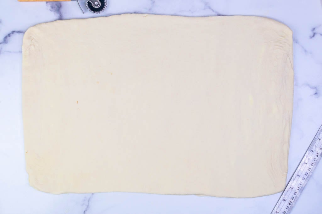 Croissant dough rolled out into large rectangle