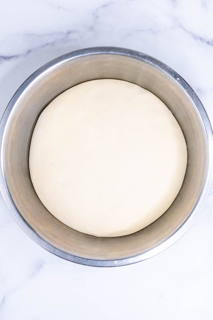 Croissant dough doubled in bowl at the end of fermentation