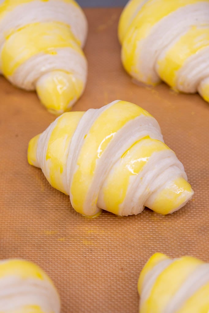 Egg wash painted on sourdough croissants