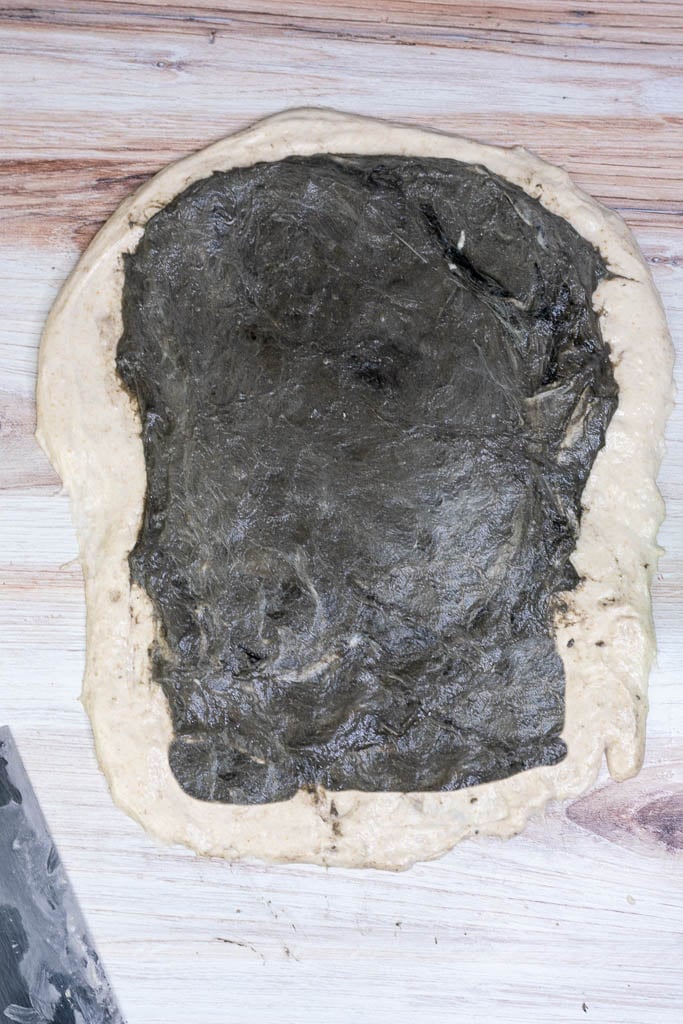 Black sesame dough laid on top of the stretched regular dough.