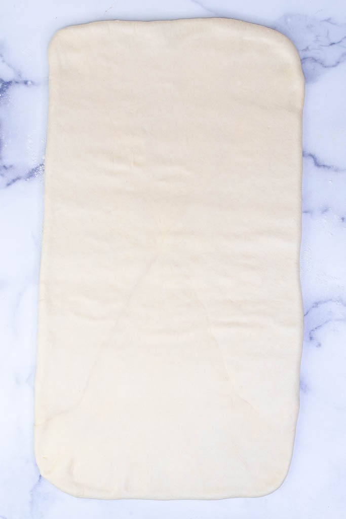 Rolling out croissant dough for first turn