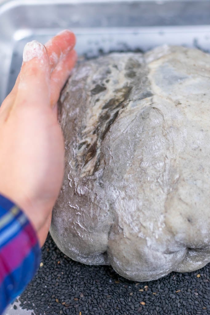 Topping black sesame sourdough with black sesame seeds