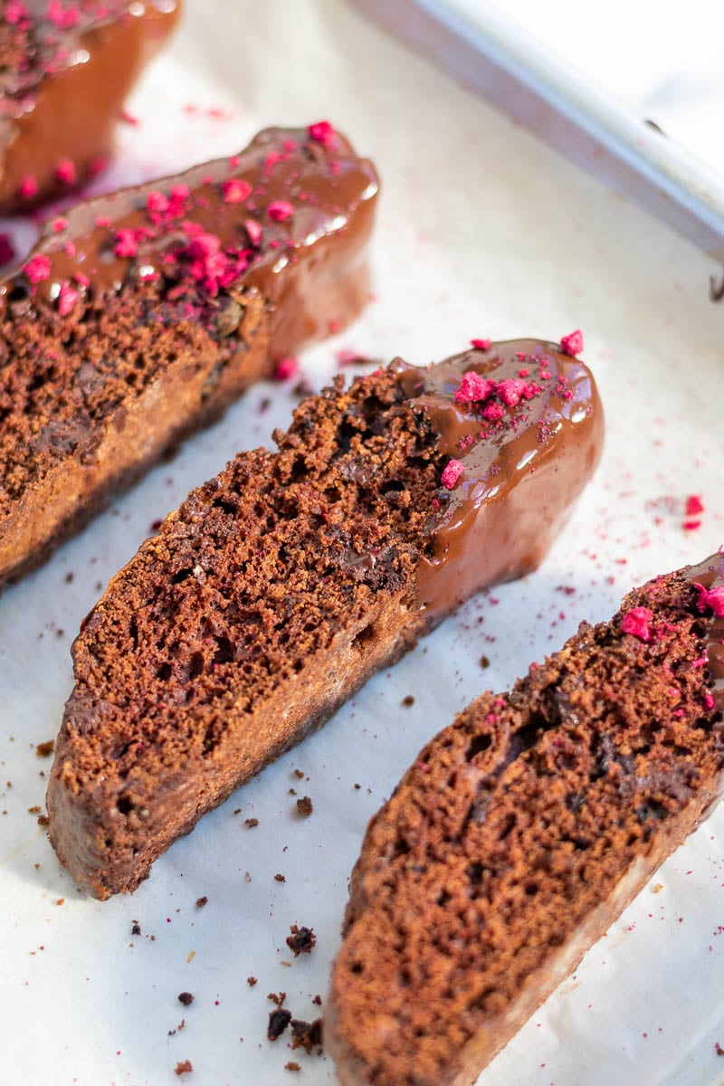 Close up of chocolate sourdough biscotti and sprinkled with dried raspberries