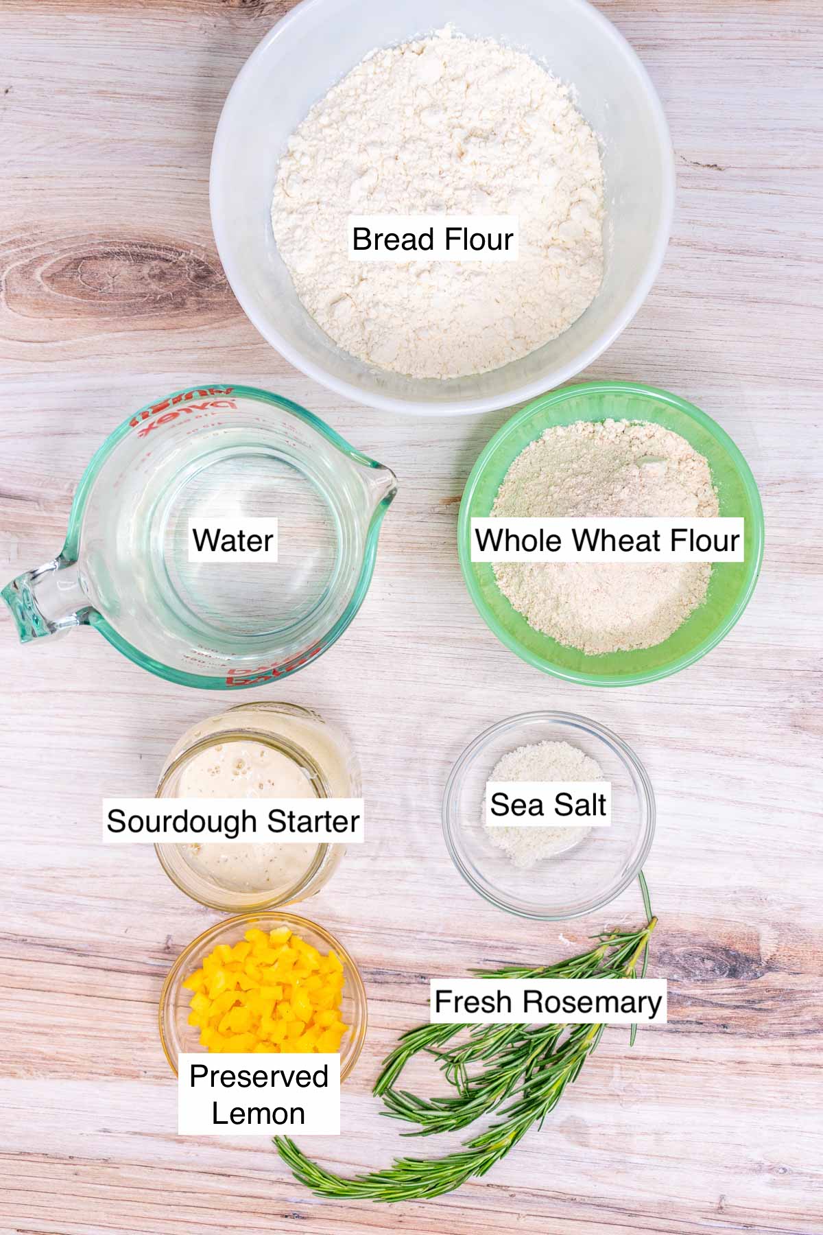 Ingredients needed for preserved lemon and rosemary sourdough including bread flour, whole wheat flour, water, rosemary, sea salt, sourdough starter, and preserved lemon