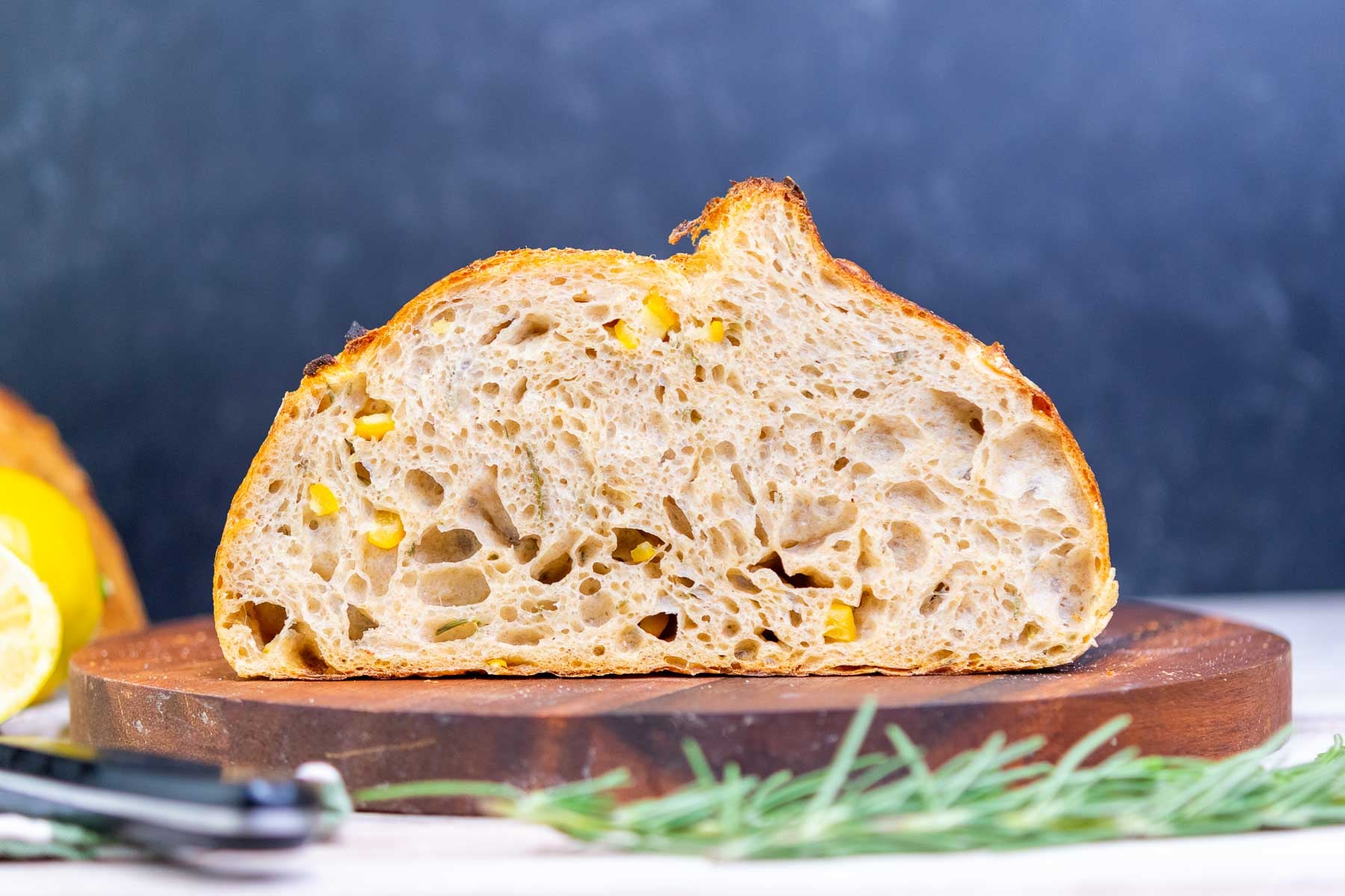 Cut interior of lemon and rosemary sourdough bread on a cutting board