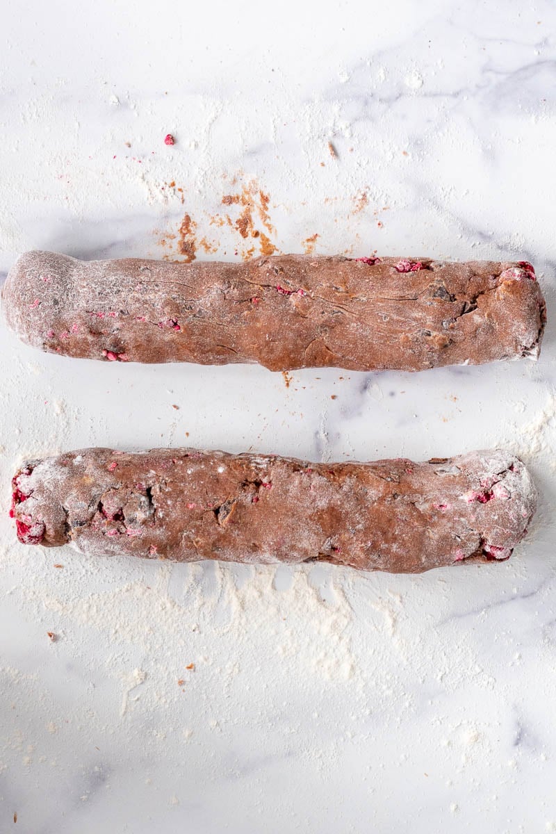 Logs of chocolate sourdough biscotti on floured surface