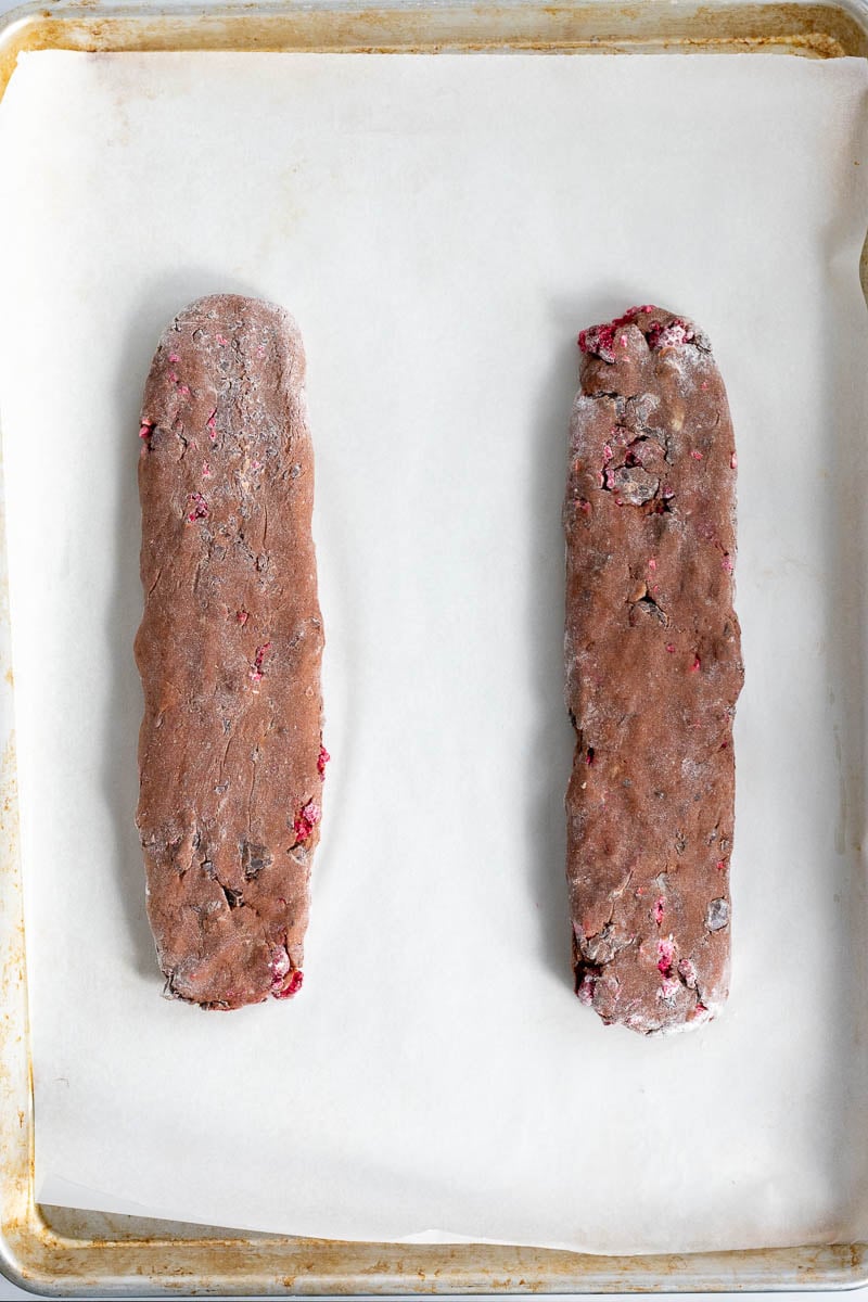 Sourdough biscotti dough in long rectangles parallel to each other on a baking pan