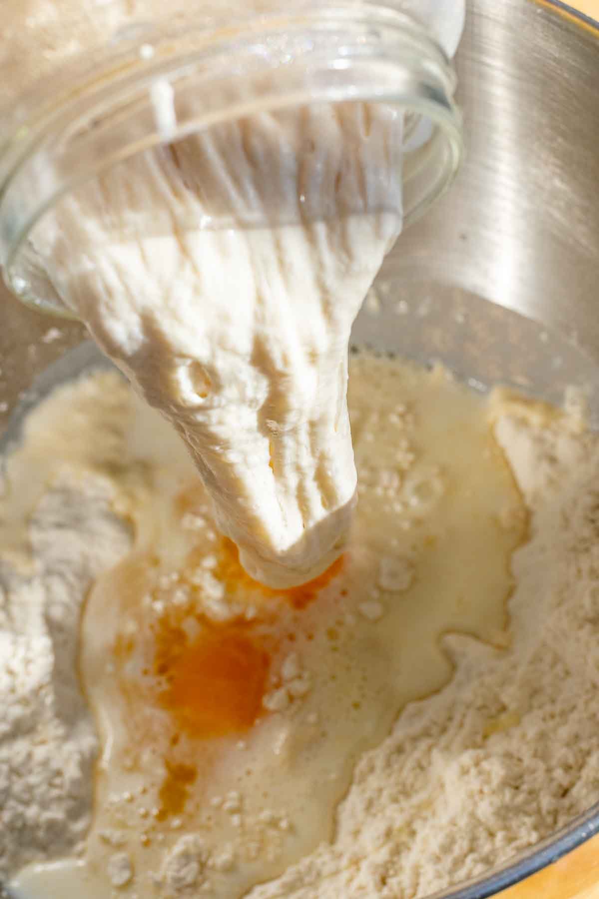 Adding starter to babka dough in stand mixer bowl