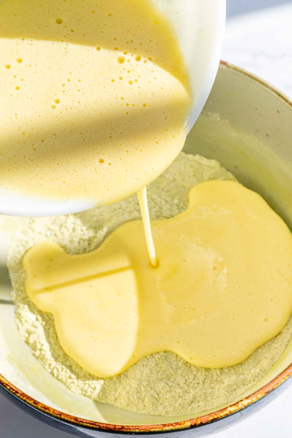 Pouring wet ingredients into dry ingredients