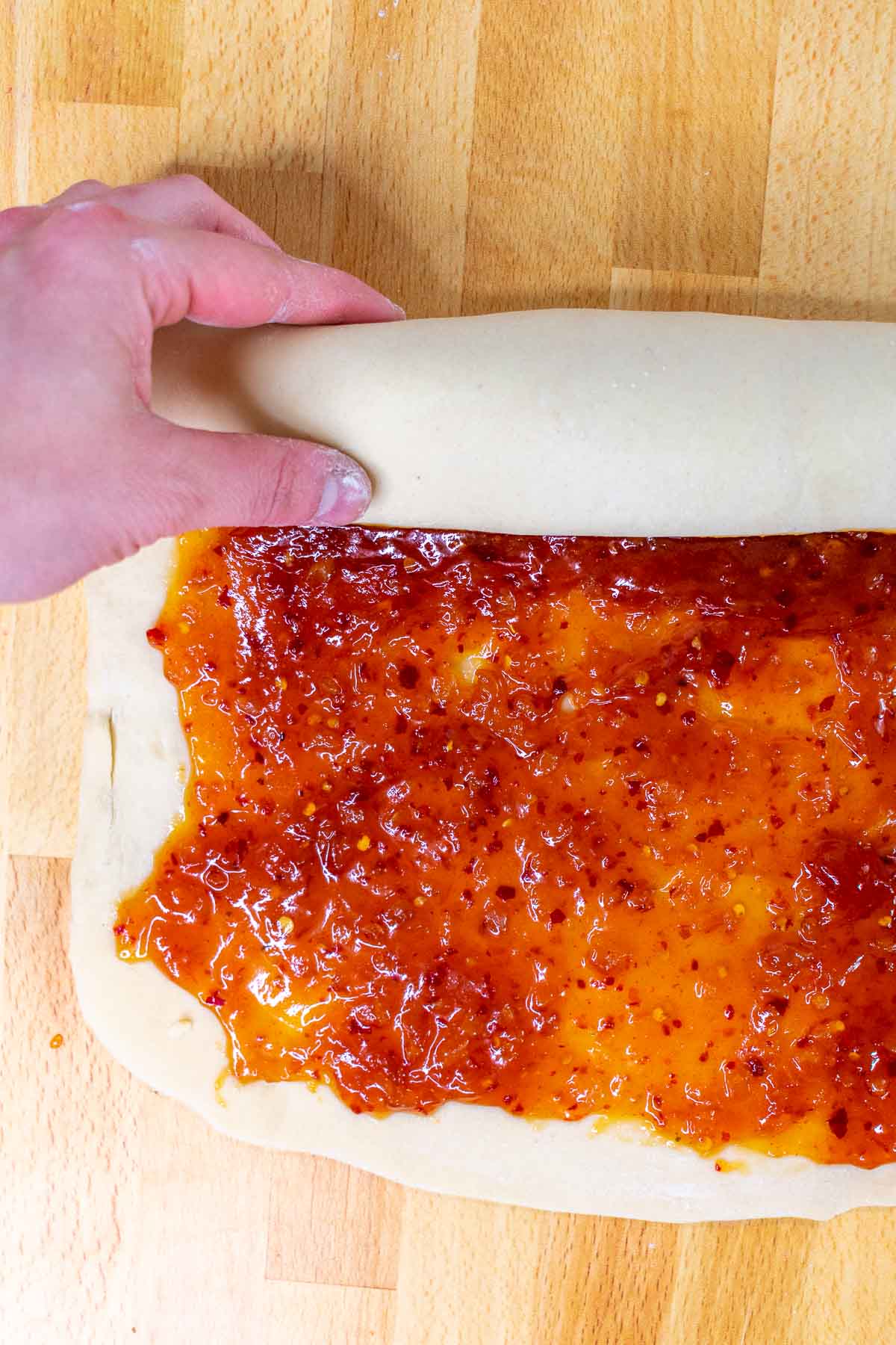 Rolling up babka into a log with jam