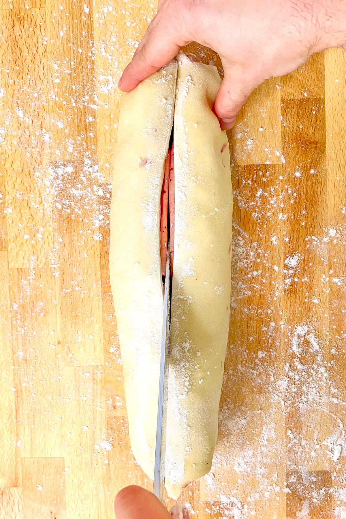 Slicing sourdough babka in half with knife