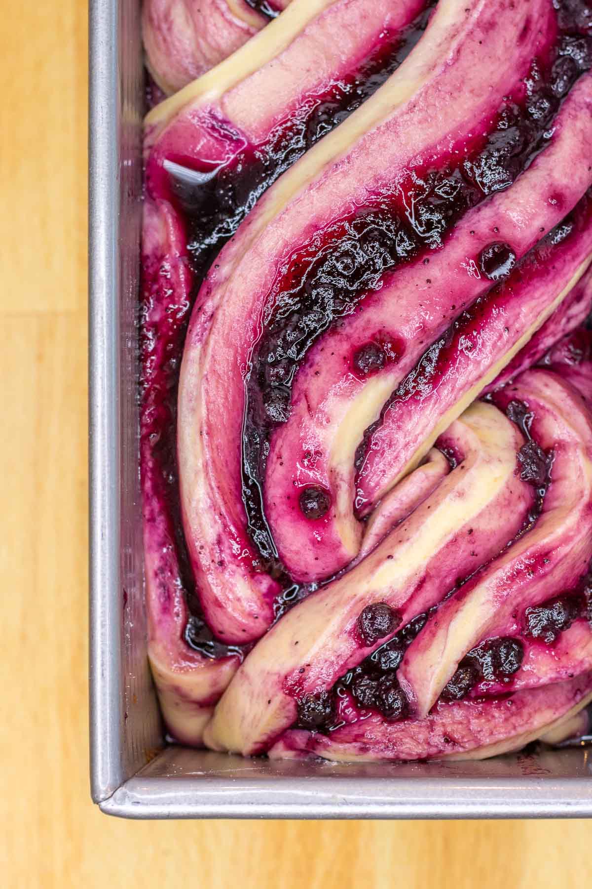 Close up of sourdough babka with blueberry jam in pan