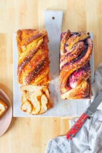 Two sourdough babkas with jam on cutting board