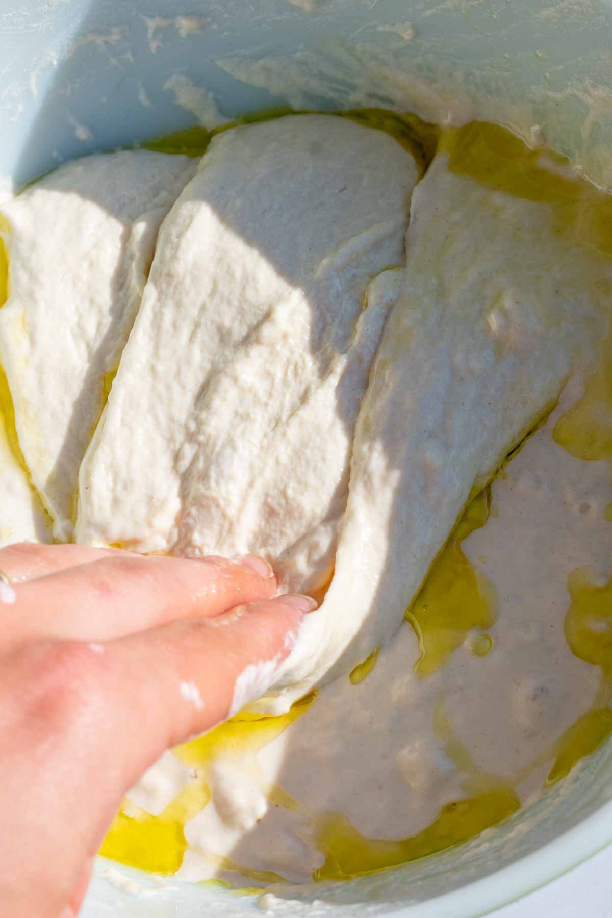 Hand folding the dough down