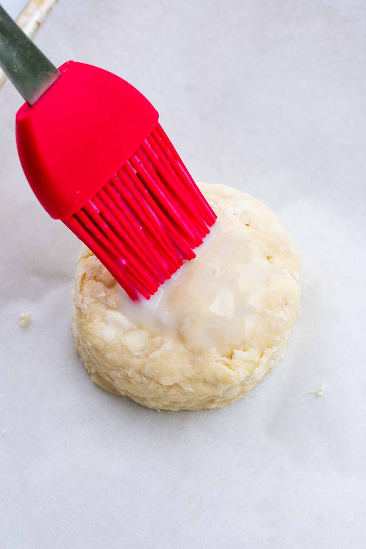 Brushing buttermilk on top of sourdough shortcake