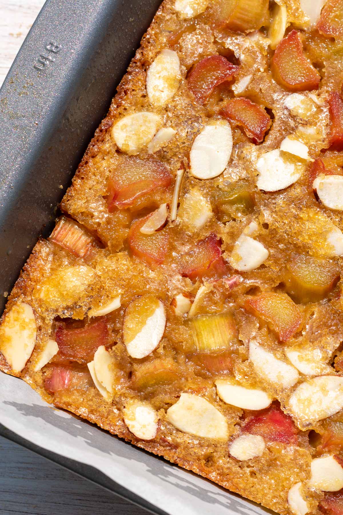 Close up of baked sourdough blondies with rhubarb and almonds