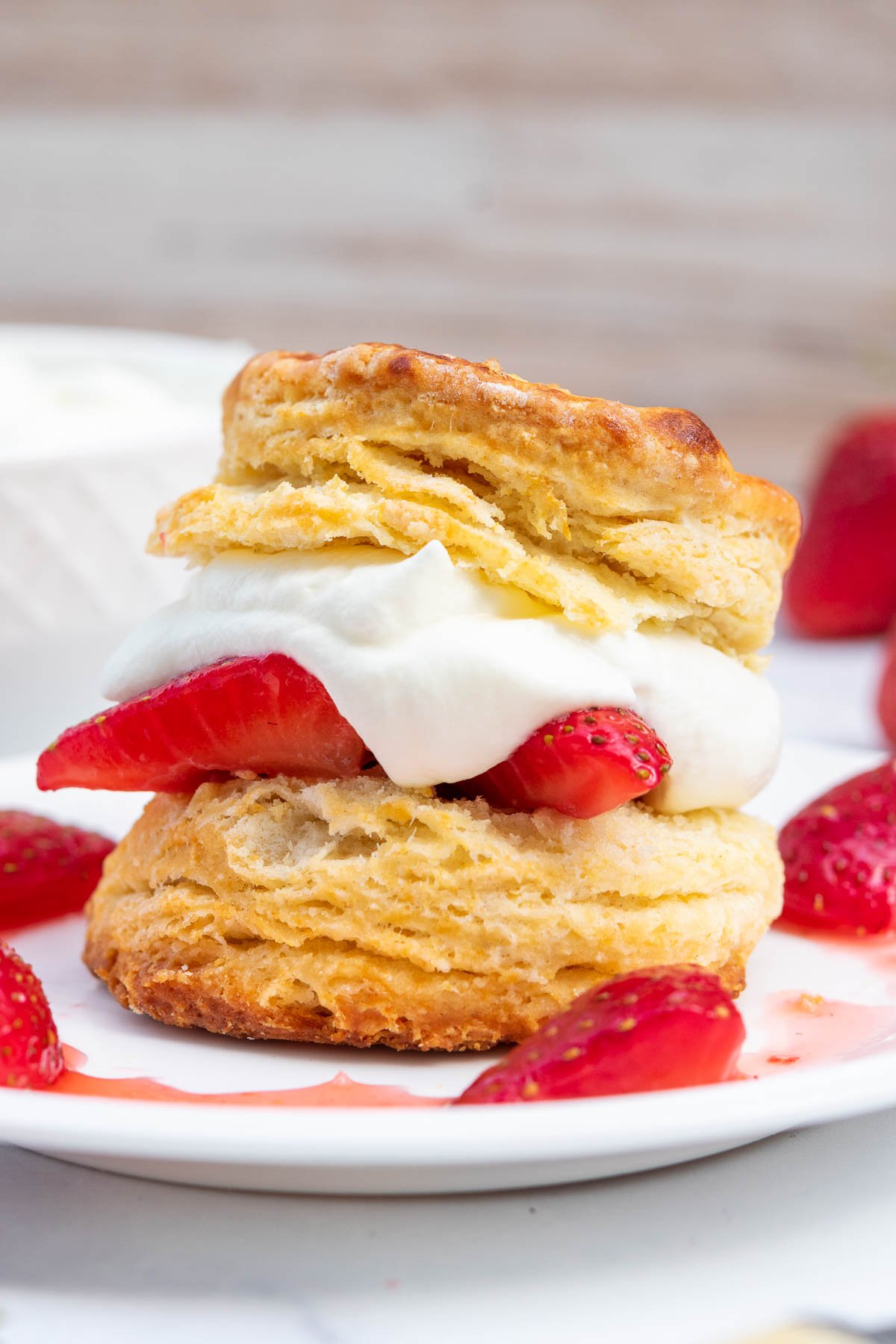A flaky sourdough strawberry shortcake on a plate
