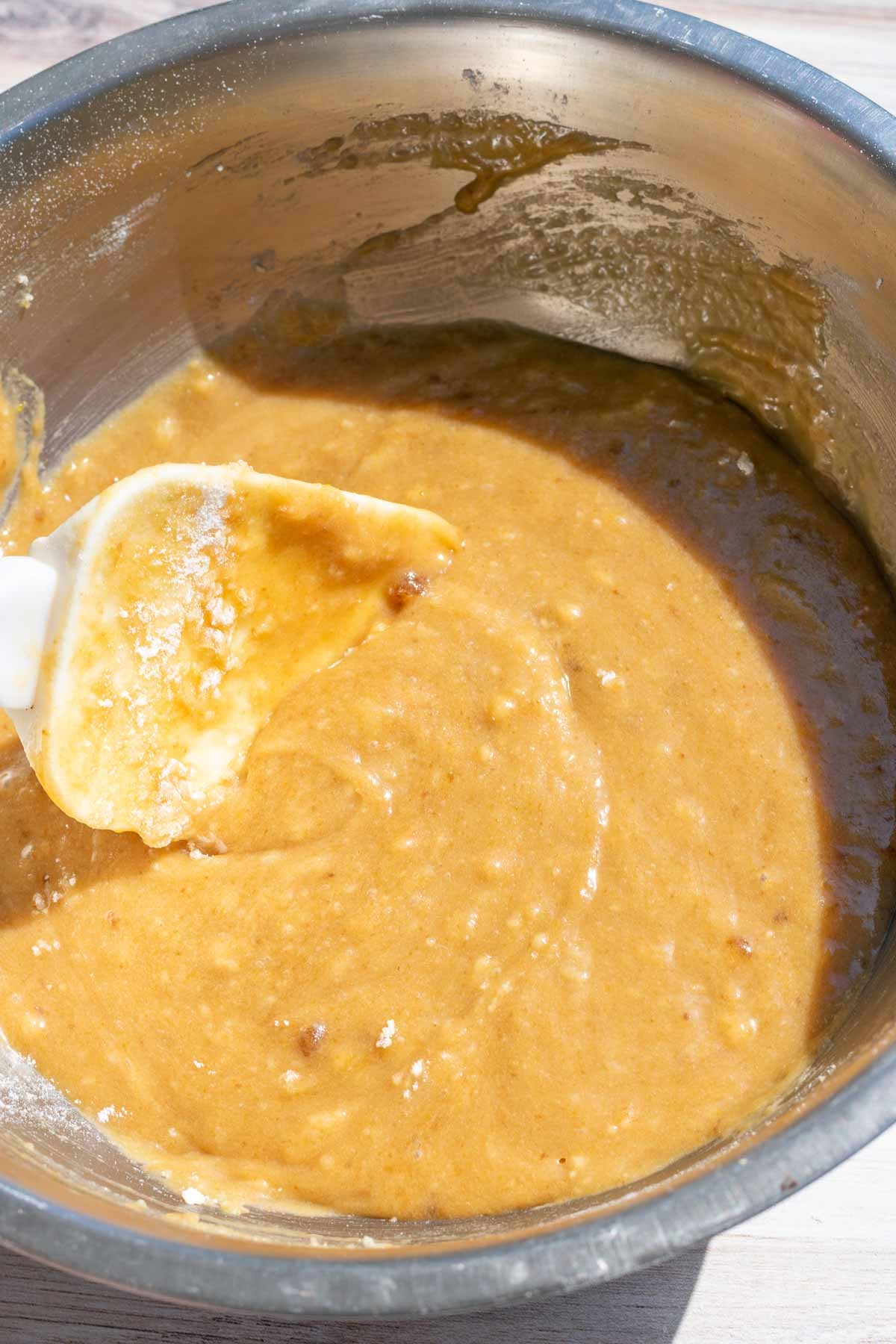 Mixed blondie batter in bowl with spatula