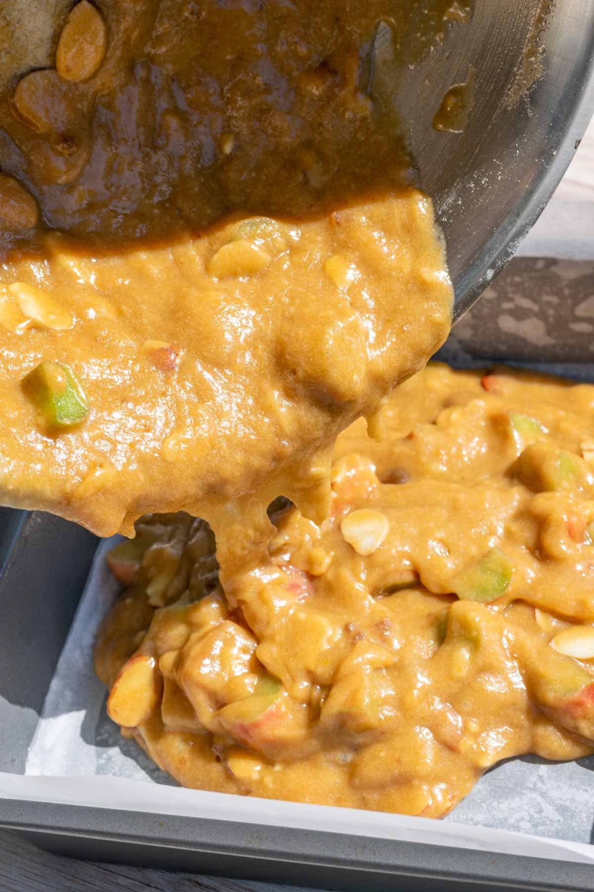 Pouring sourdough rhubarb blondie batter into prepared baking pan