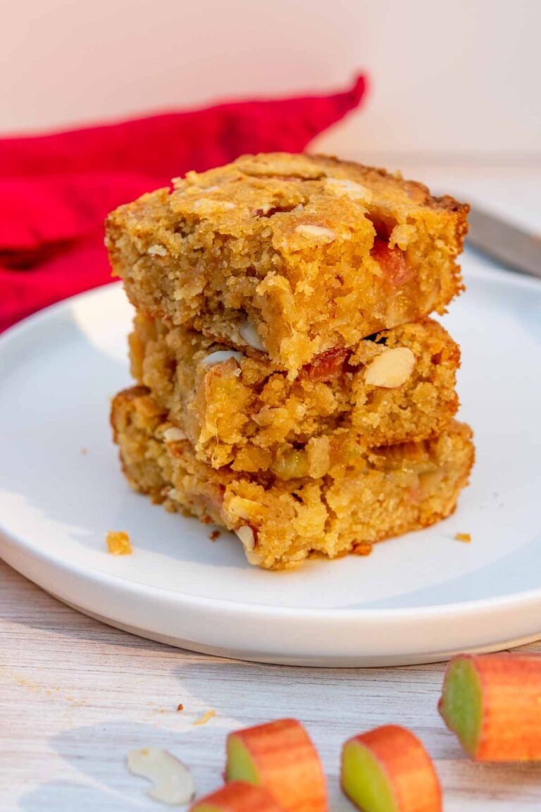 Sourdough blondies with rhubarb and almonds stacked on a plate