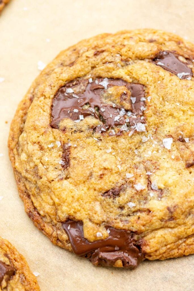 Close up of a sourdough discard chocolate chip cookie with flaky salt