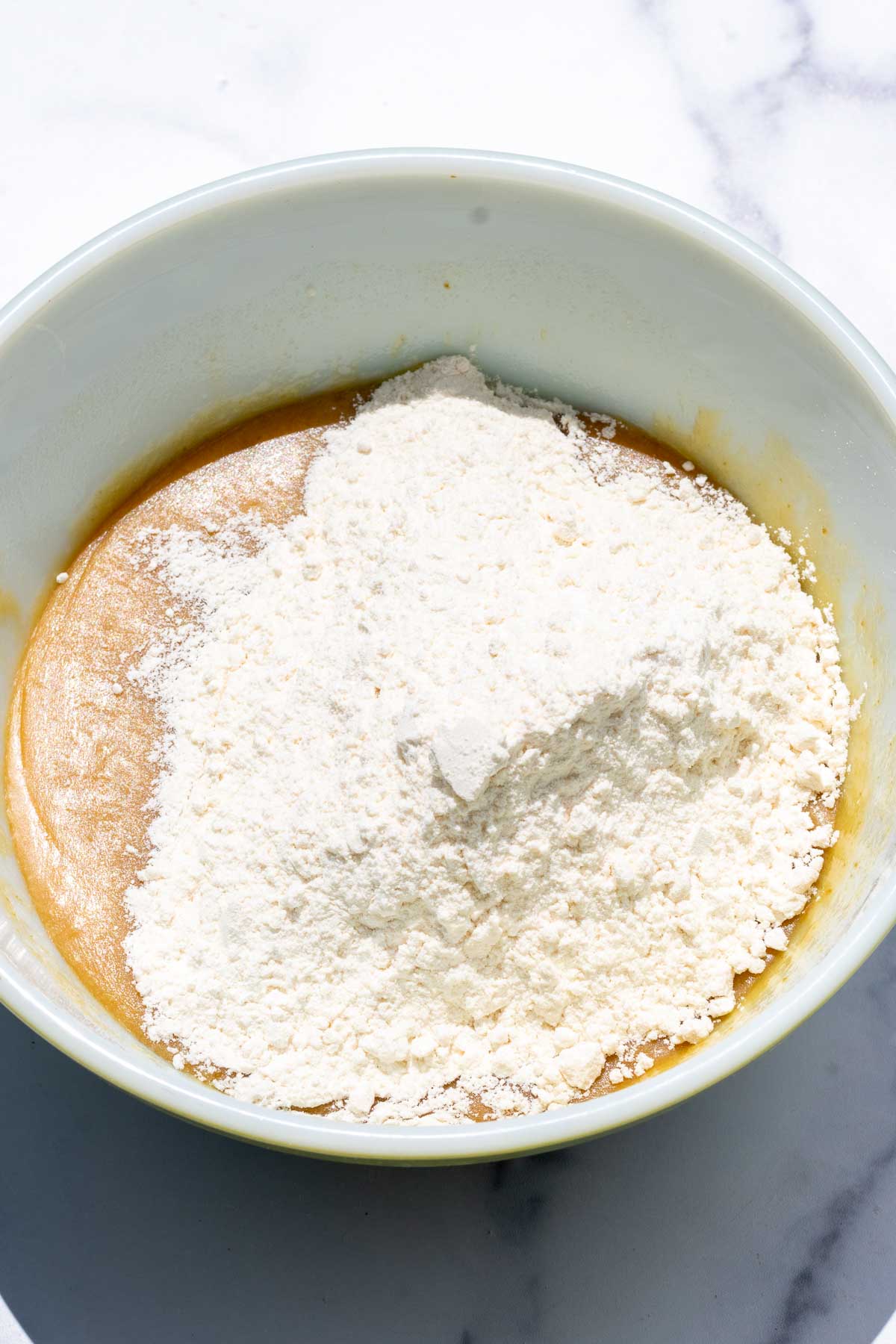 Dry ingredients added to bowl on top of wet ingredients