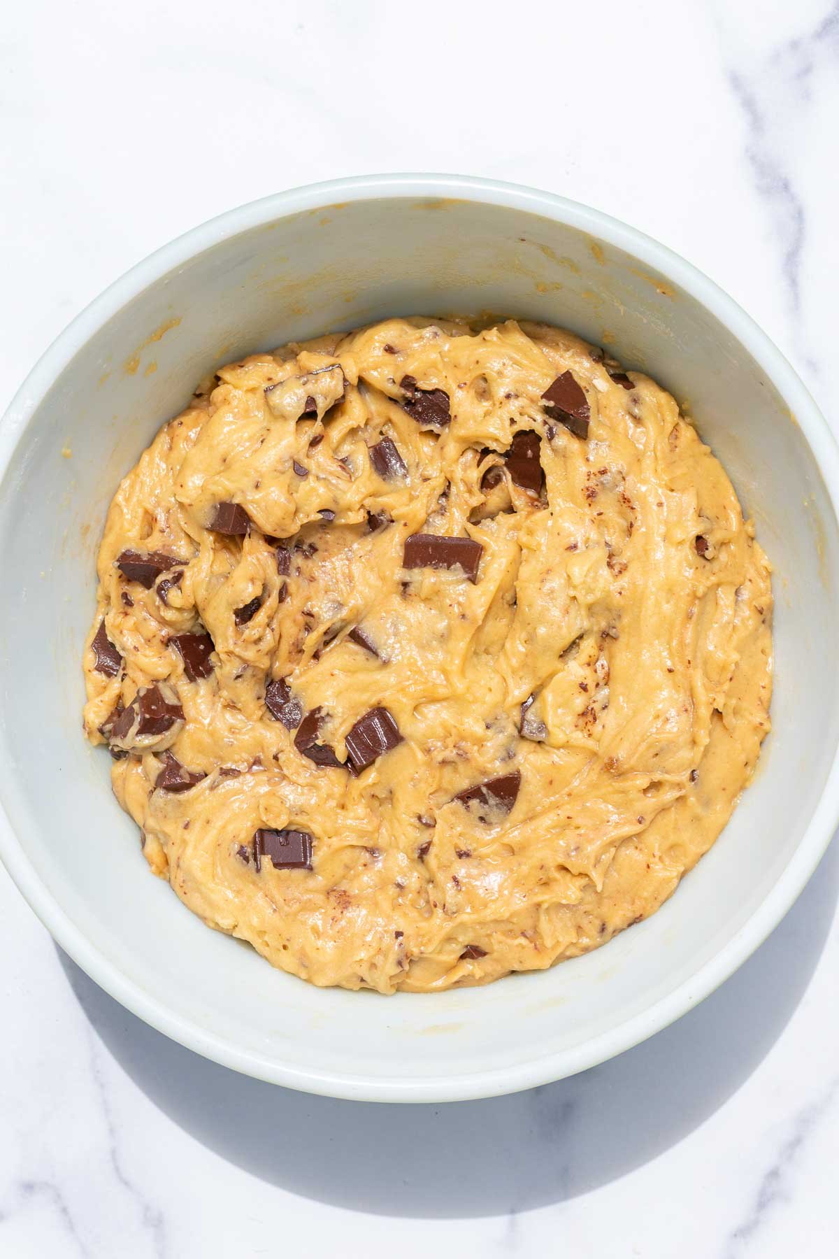 Sourdough discard chocolate chip cookie batter in bowl before chilling