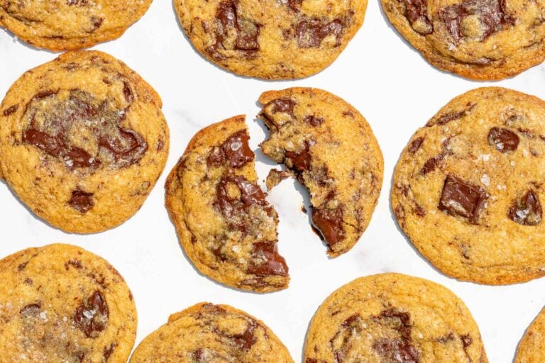 Many Gooey Sourdough Discard Chocolate Chip Cookies on a marble surface