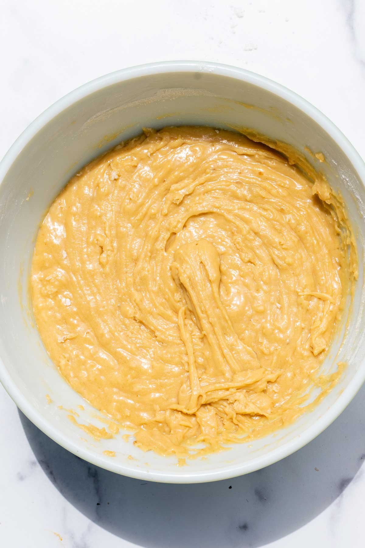 Thick sourdough discard chocolate chip cookie batter in bowl before adding chocolate