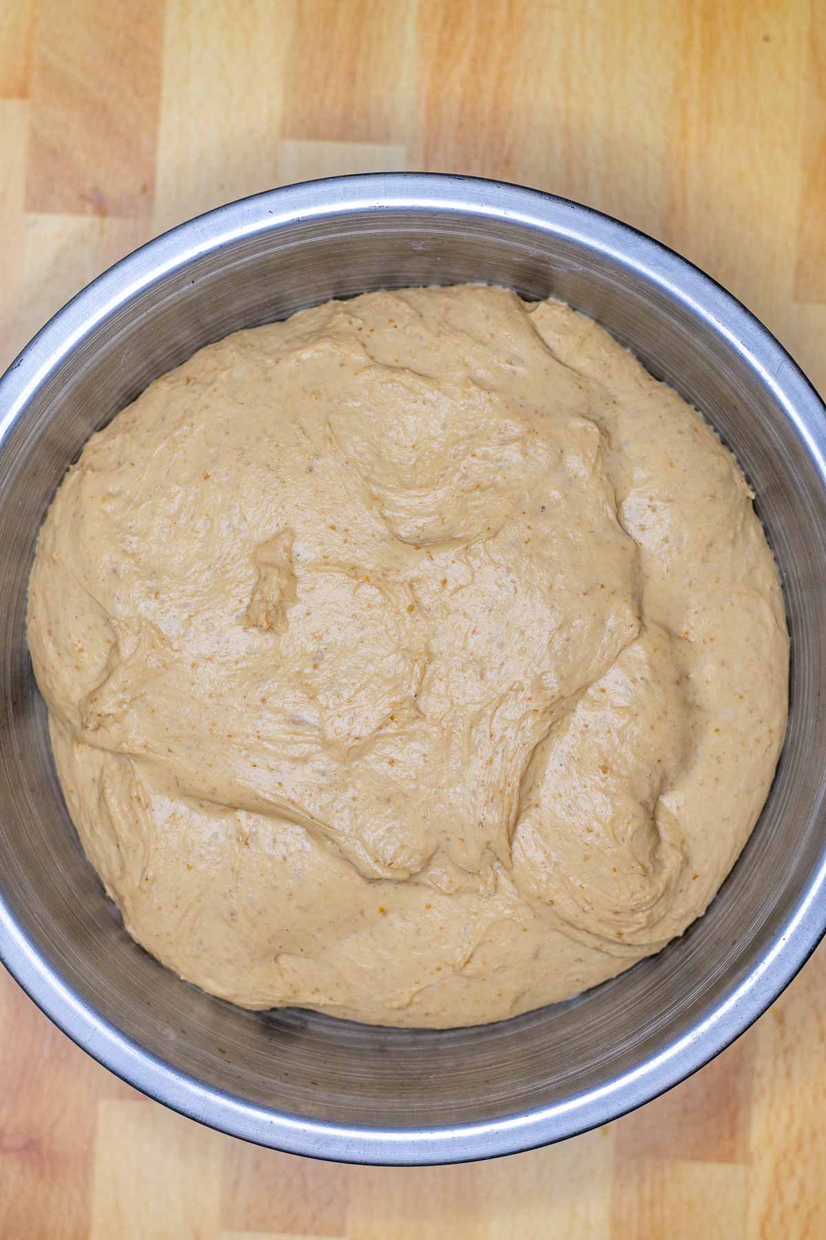 Sourdough bagel dough in bowl at the end of bulk fermentation, doubled in size.