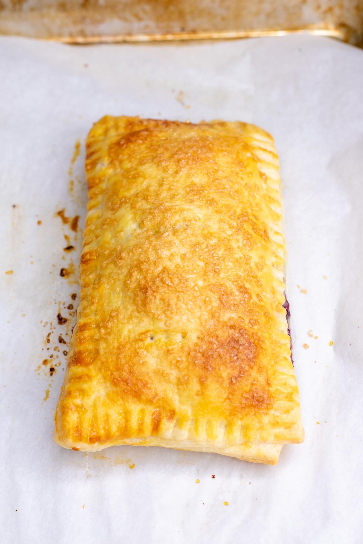 A baked sourdough pop tart on a sheet pan.