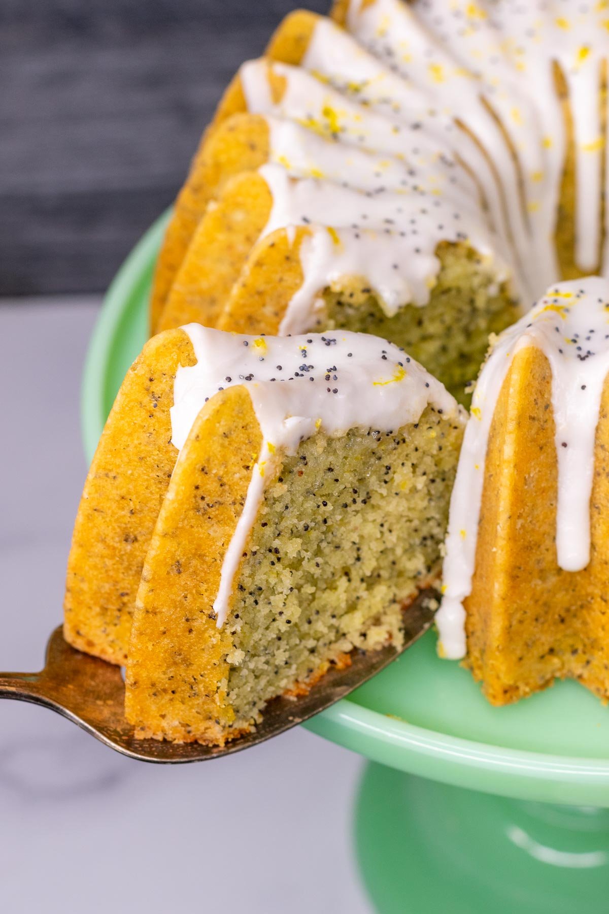 Cutting a slice of sourdough lemon bundt cake