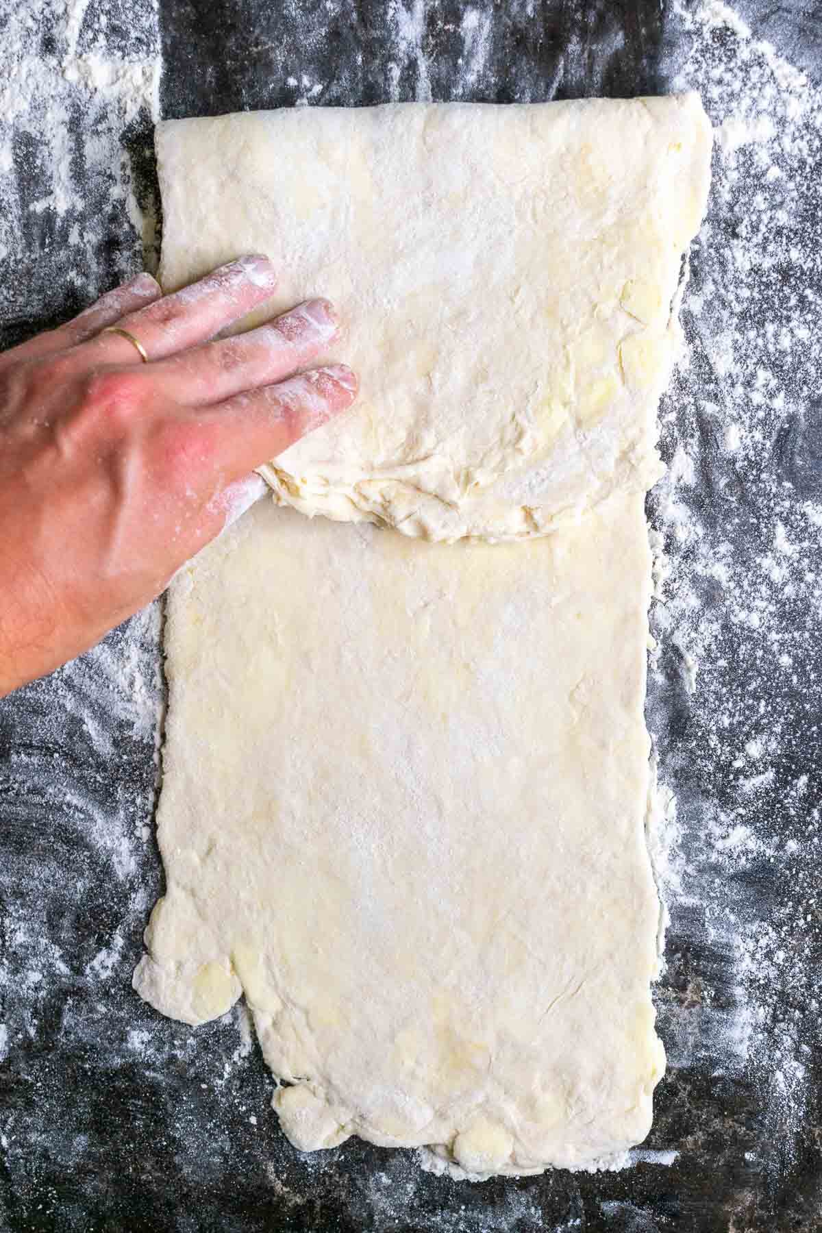 Folding the top third of the dough down.