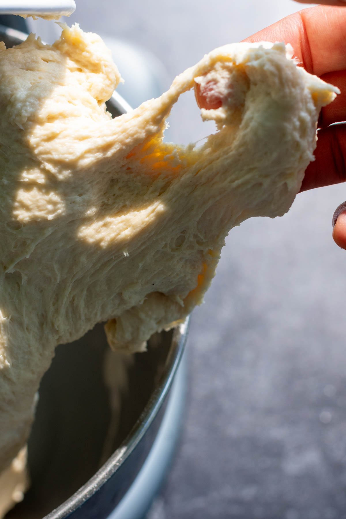 Hand stretching sourdough garlic knot dough, but it tearing easily.