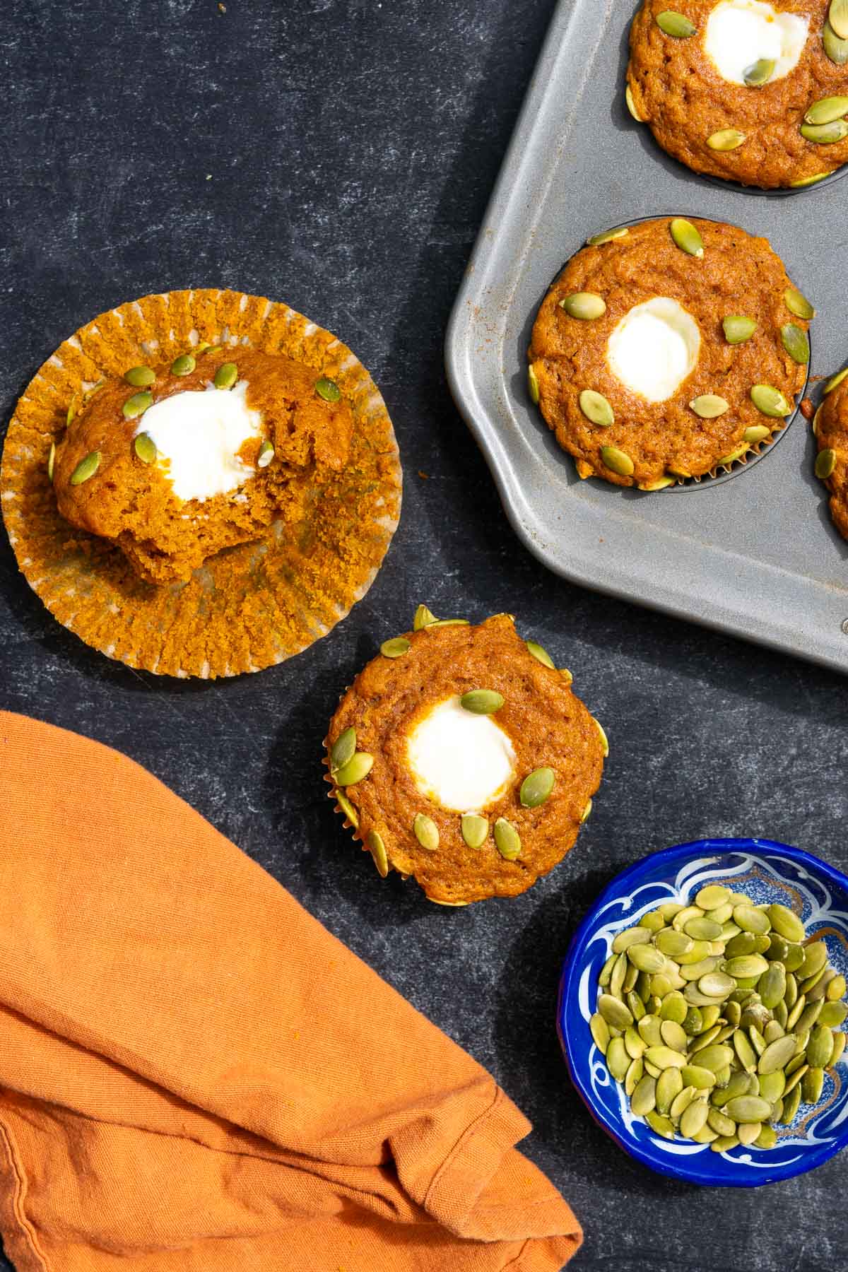 Sourdough pumpkin muffins with cream cheese centers and pumpkin seeds.