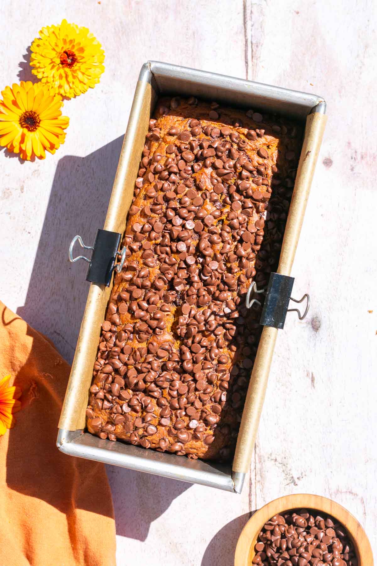 Baked sourdough pumpkin chocolate chip bread in bread loaf pan.