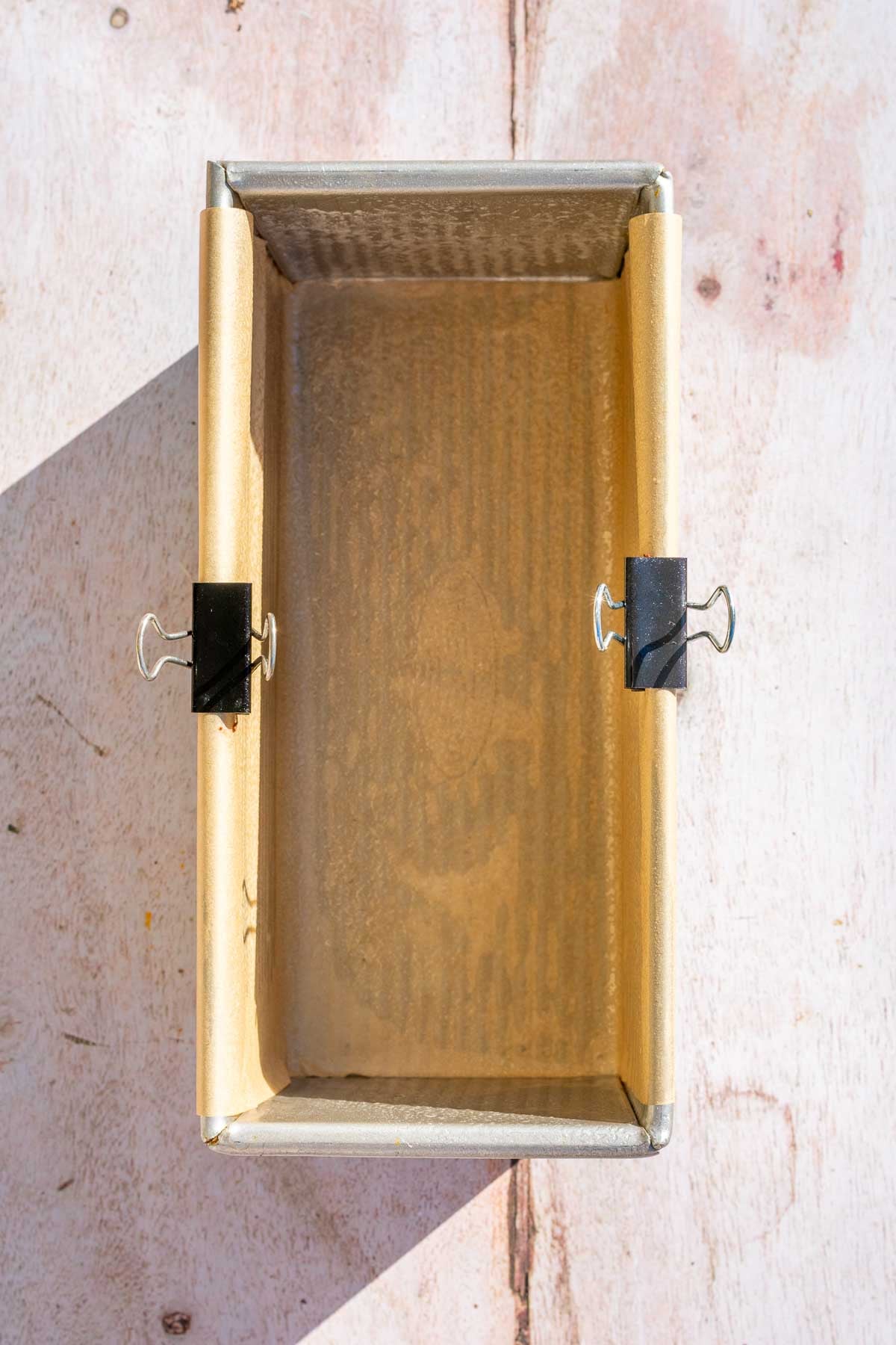 Bread loaf pan lined with parchment paper.
